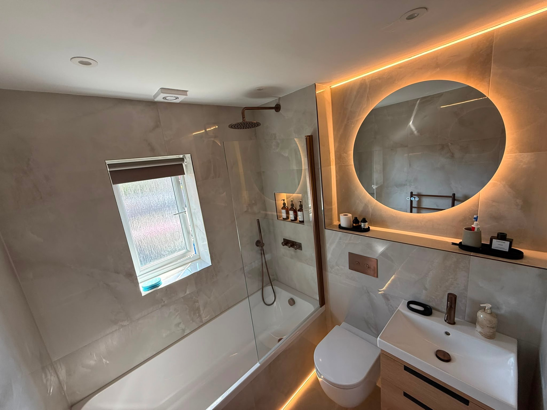 Bronze Rainfall Shower over Bath & Backlit Round Mirror by DPS Plumbing & Bathrooms in Worsley, Salford