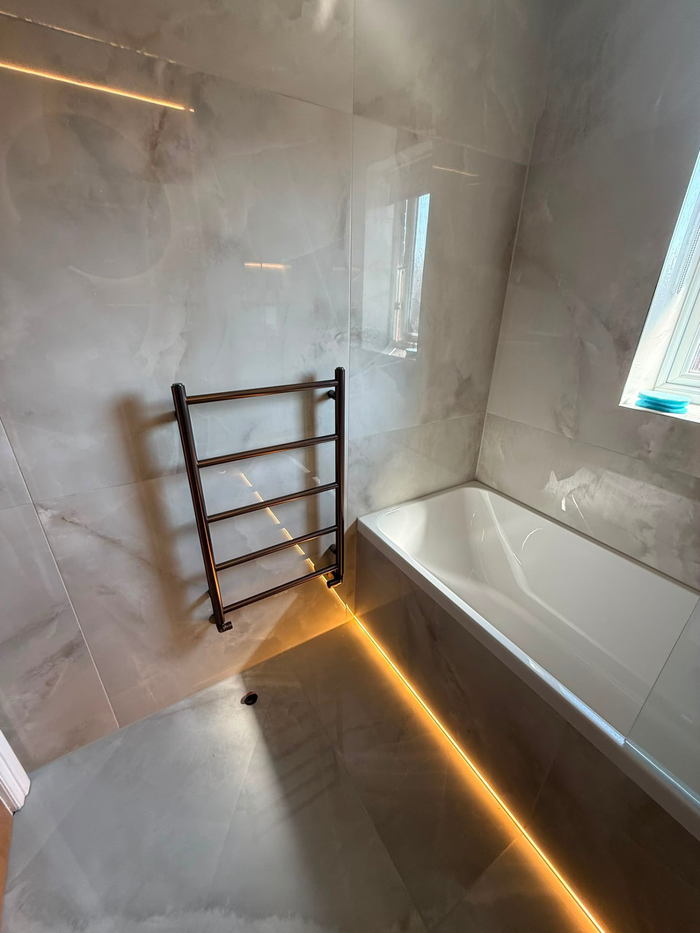 Polished Porcelain Bathroom with Bronze Towel Rail by DPS Plumbing & Bathrooms in Swinton, Salford