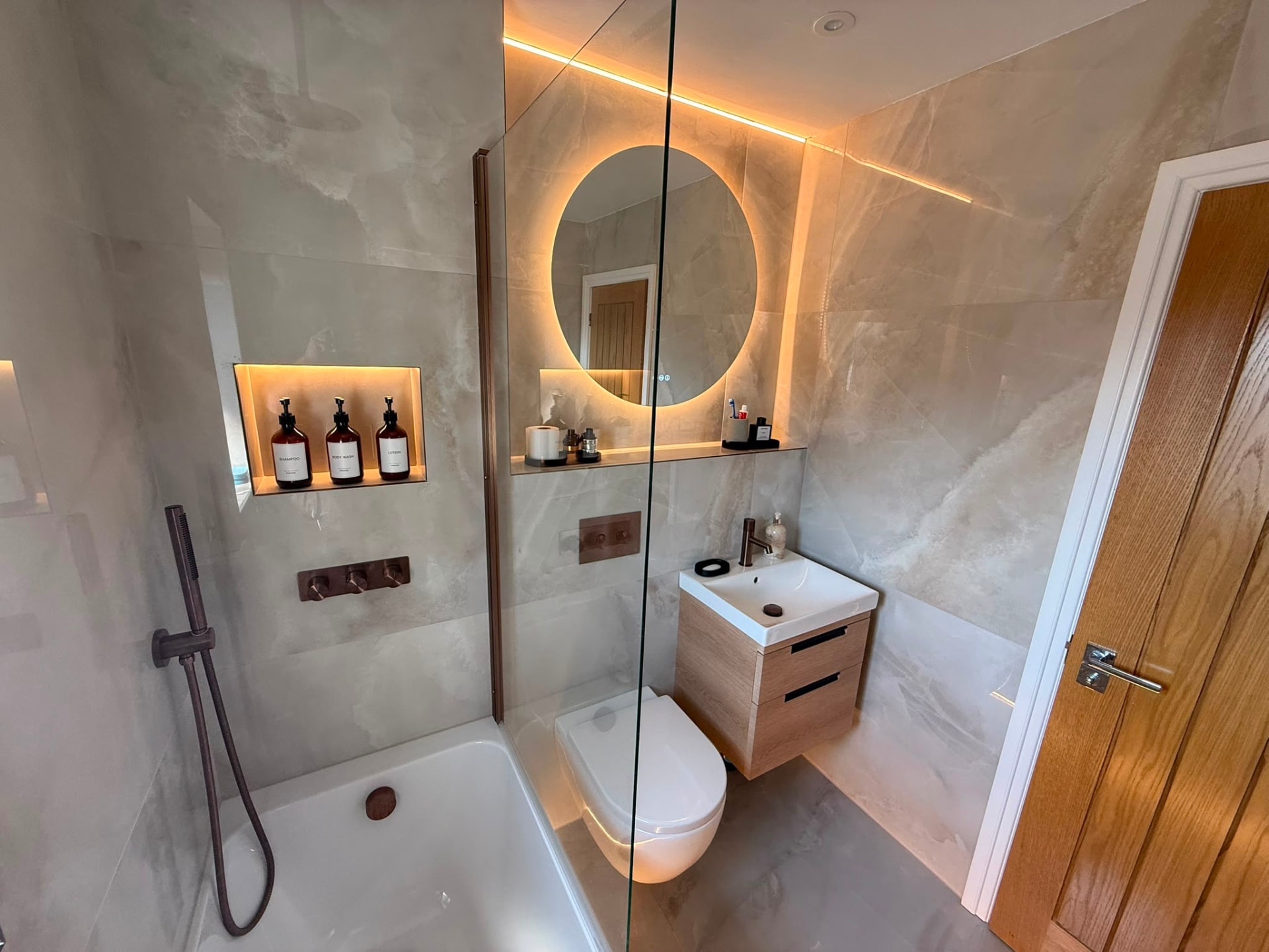 Compact Bathroom with Bronze Brassware & Oak Storage by DPS Plumbing & Bathrooms in Eccles, Salford