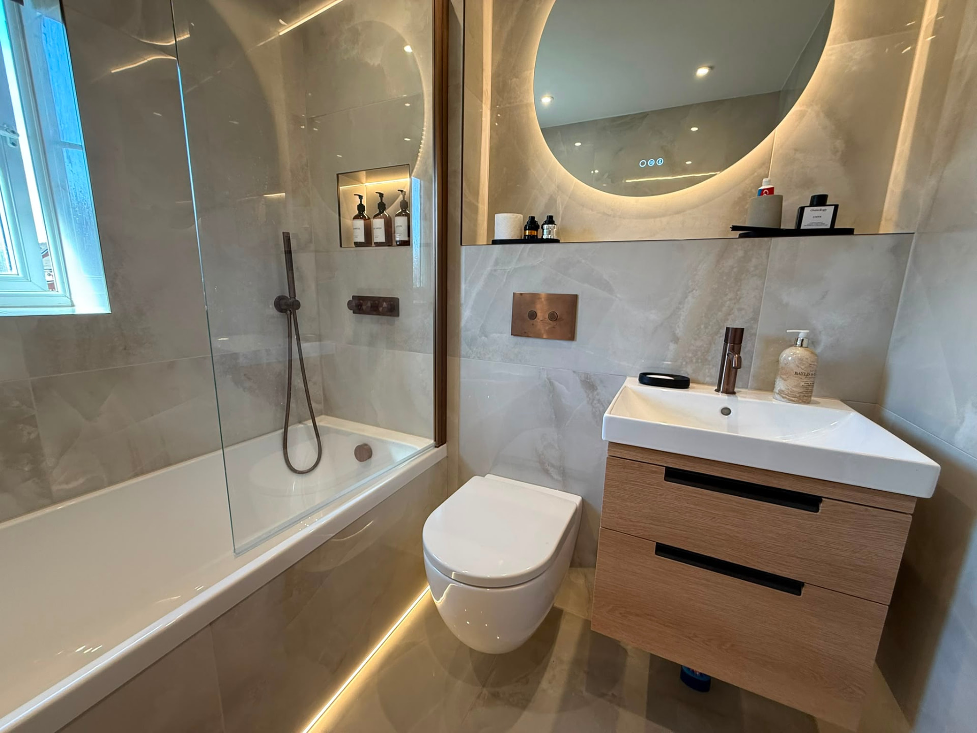 Modern Bathroom with Concealed Cistern & Backlit Mirror by DPS Plumbing & Bathrooms in Whitefield, Bury